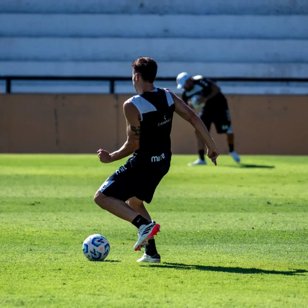 A soccer player training on a sunny day, showcasing agility and skill.