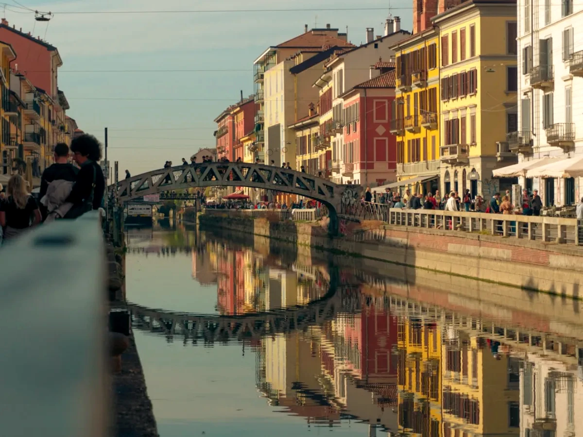 a bridge over a body of water with buildings around it